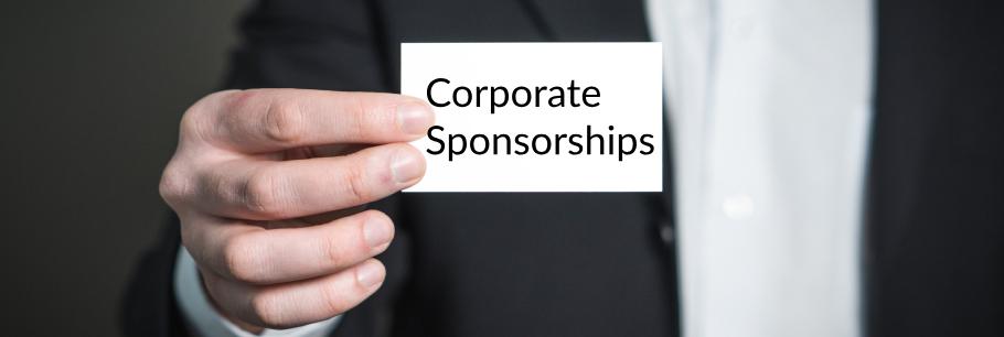 man holding Corporate Sponsorships business card
